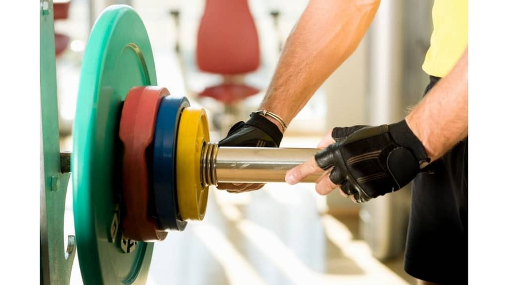 Hands with weights on bench press